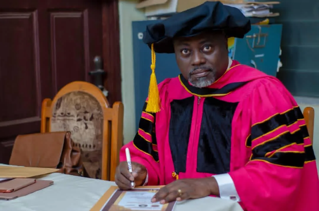 Apostle Anthony signing a graduate certificate